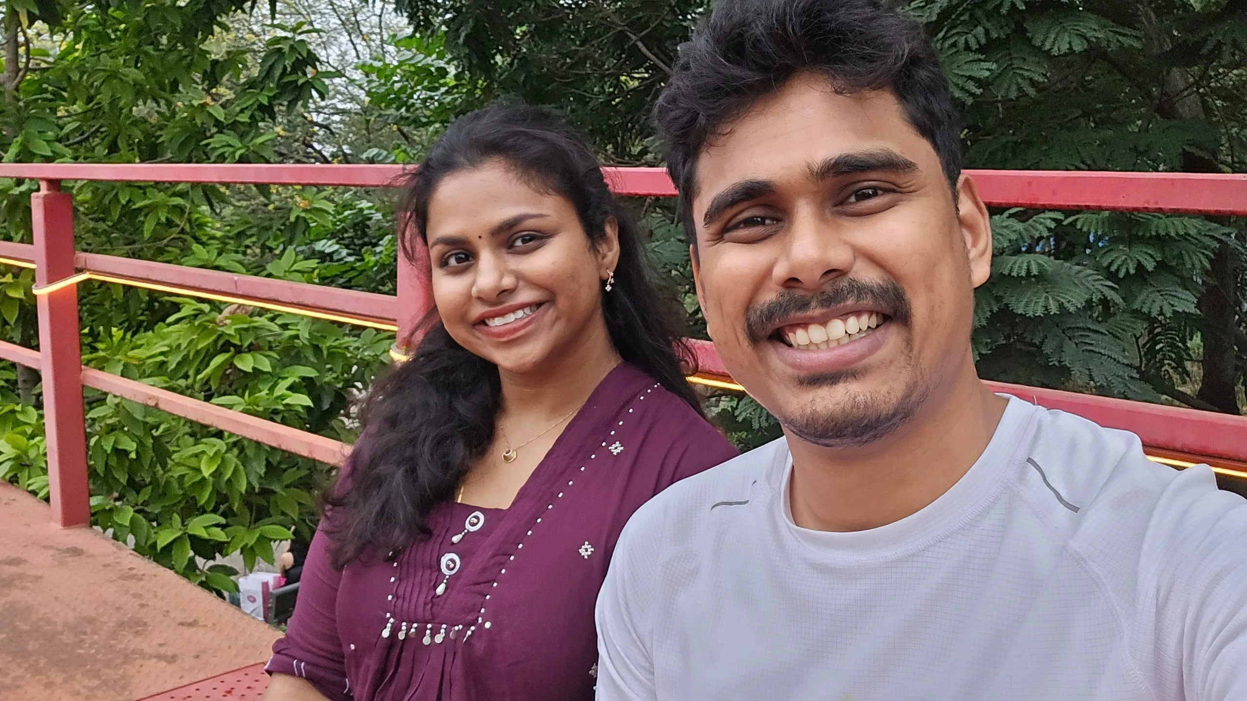 Swathi and Gautham close together, laughing outdoors